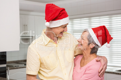 Senior couple wearing santa hats