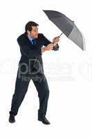 Man holding umbrella to protect himself from the rain