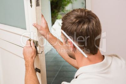 Man fixing locks with screwdriver