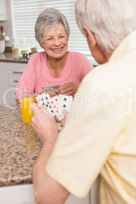 Senior couple playing cards at the counter