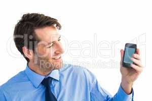 Smiling businessman showing smartphone to camera