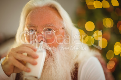 Santa claus drinking a glass of milk