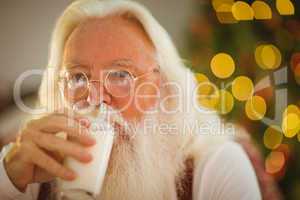 Santa claus drinking a glass of milk