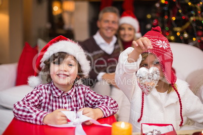 Siblings sitting on the floor in front of their parents