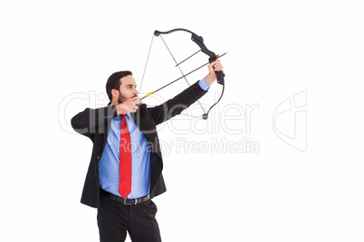 Focused businessman shooting a bow and arrow