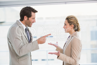 Angry man pointing at his colleague