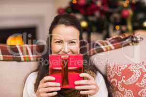 Pretty brunette woman holding christmas gift