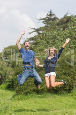 Cute couple jumping and smiling