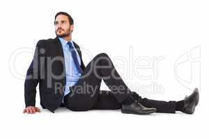 Relaxed businessman sitting on the floor