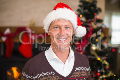 Portrait of a smiling handsome man in santa hat