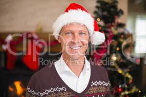 Portrait of a smiling handsome man in santa hat
