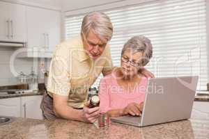 Senior couple looking up medication online