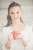 Pretty brunette holding a mug