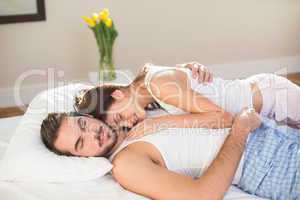 Young couple cuddling in bed