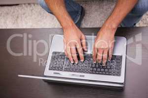 Man using his laptop on coffee table