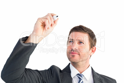 Serious businessman writing with marker