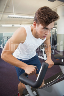 Fit man working out on the exercise bike