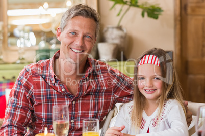 Casual father and daughter smiling at camera