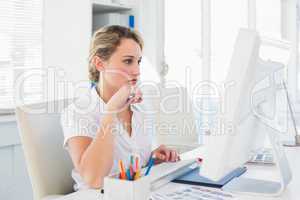 Focused blonde editor working at her desk
