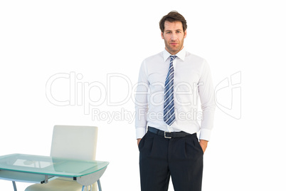 Businessman standing with hands in pockets