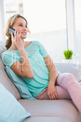 Blonde woman on the phone on the couch