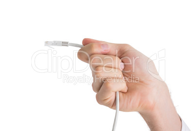Hand of businessman holding white cable