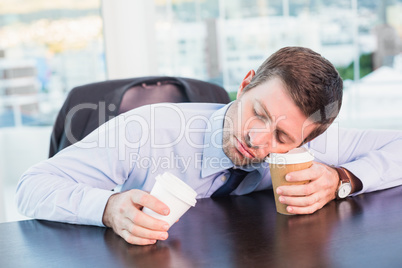 Exhausted businessman sleeping at his desk