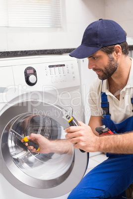 Handyman fixing a washing machine