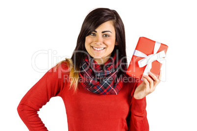 Happy brunette showing a gift