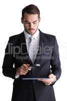 Concentrated businessman using magnifying glass