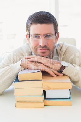 Casual businessman with books at his desk
