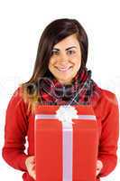 Smiling brunette holding a gift with white bow