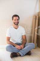 Happy man sitting on the floor