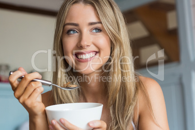 Cute blonde having cereal for breakfast