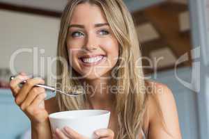 Cute blonde having cereal for breakfast