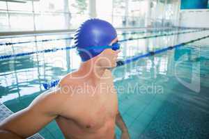 Swimmer looking away in pool at leisure center