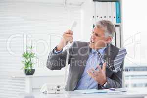 Angry businessman shouting on the phone