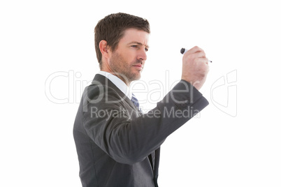 Serious businessman holding a marker and writing