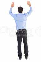 Rear view of businessman raising his arms