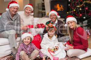 Happy family at christmas holding gifts