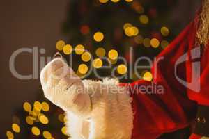 Hand of santa claus holding engagement ring