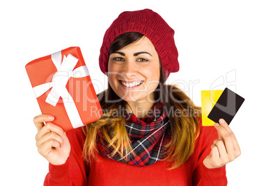 Smiling brunette holding gift and cards