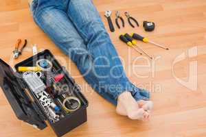 Man legs with toolbox on floor at home