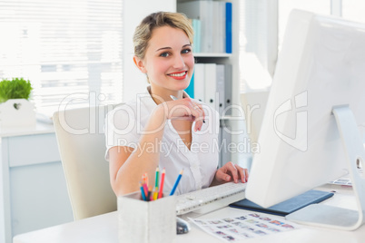 Female photo editor working on computer