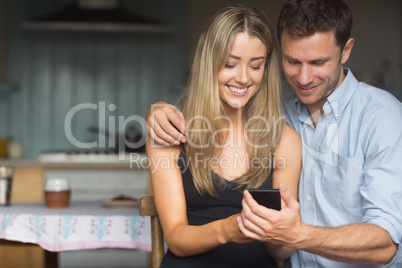 Cute couple using smartphone together