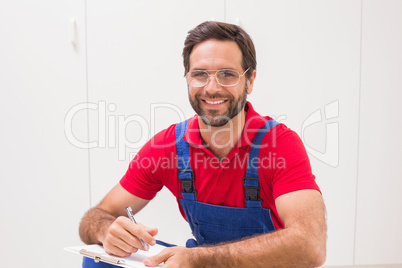 Construction worker taking notes on clipboard