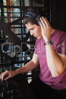 Cool dj working on a sound mixing desk