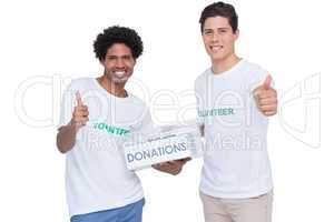 Young smiling volunteers collecting donations