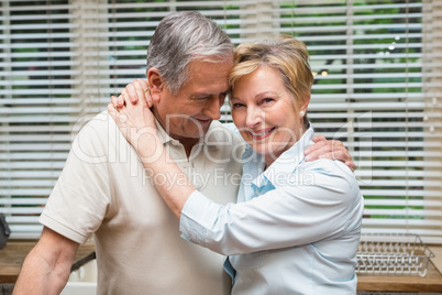 Senior couple hugging and smiling