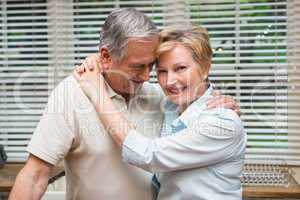 Senior couple hugging and smiling